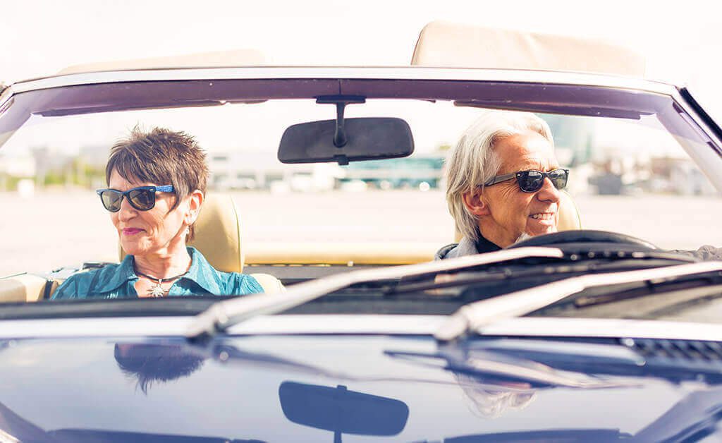 senior couple in a convertible